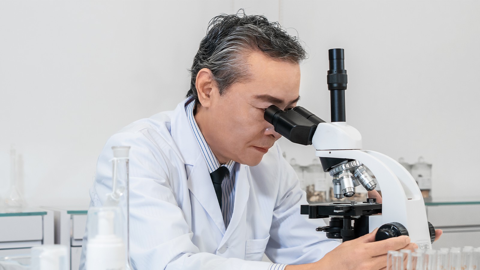 Skincare formulation expert conducting precise testing on new ingredients